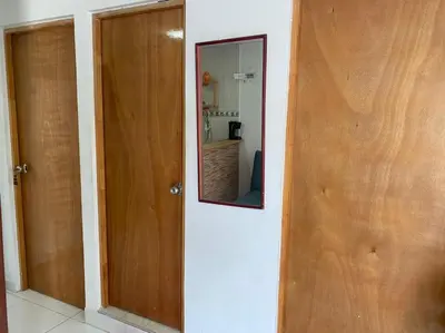 a hallway with two doors and a mirror at En mi casa cartagena in Cartagena de Indias