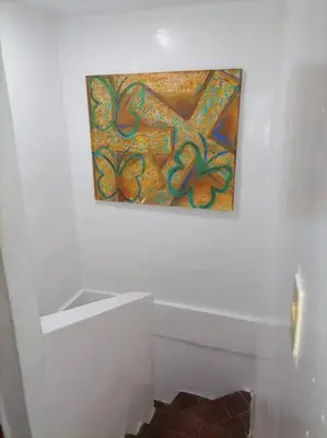 a painting hanging on a wall in a bathroom at Casa La Fe in Cartagena de Indias