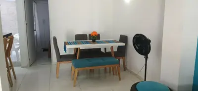 a dining room table and chairs with a vase on it at Casa La Fe in Cartagena de Indias