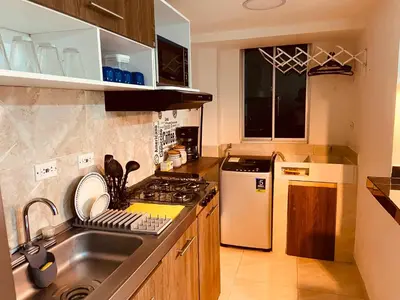a kitchen with a sink and a stove at Apartamento Exclusivo - Caribe Campestre Coveñas in Coveñas