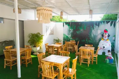 a restaurant with tables and a snowman painted on the wall at ZABDI COVEÑAS in Coveñas