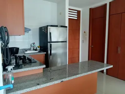 a kitchen with a stainless steel refrigerator and a sink at Costa Azul Suite 804 in Santa Marta