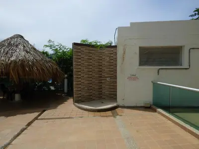 a brick wall next to a building with a window at Costa Azul Suite 804 in Santa Marta
