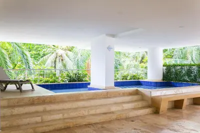 a pool with blue tiles on the stairs of a house at 1 Bedroom Apartment Morros. Beach access in Cartagena de Indias