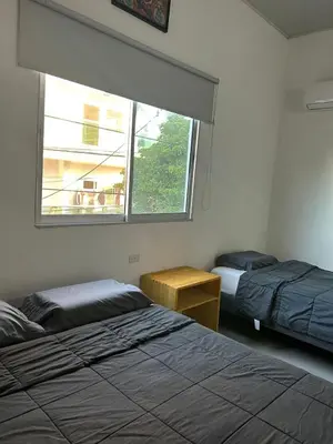 a bedroom with two beds and a window at ALTAVITA apart completo a 100 m del mar in Puerto Colombia