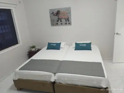 a bedroom with a large bed with blue pillows at Ayenda Isla de Manga in Cartagena de Indias