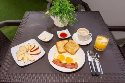 a table with a breakfast plate of eggs and toast at Ayenda Isla de Manga in Cartagena de Indias