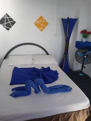 a bed with two blue towels on it at Hostal azul beach isla baru in Playa Blanca