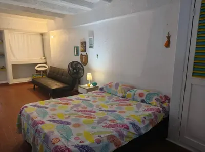 a bedroom with a bed and a couch at @casa__grace in Cartagena de Indias