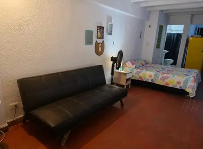 a living room with a couch and a bed at @casa__grace in Cartagena de Indias