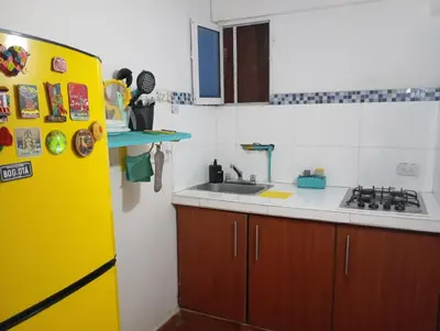 a kitchen with a yellow refrigerator and a sink at @casa__grace in Cartagena de Indias