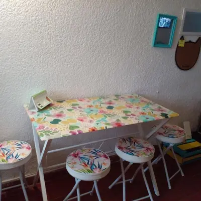 a table with four stools and a table with a bed at @casa__grace in Cartagena de Indias