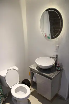 a bathroom with a sink and a toilet and a mirror at Apartaestudio Altamar in Cartagena de Indias