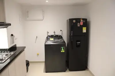 a black refrigerator in a kitchen next to a stove at Apartaestudio Altamar in Cartagena de Indias