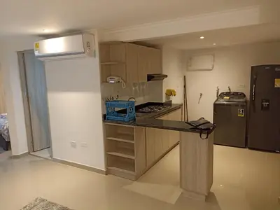 a small kitchen with a counter and a refrigerator at Apartaestudio Altamar in Cartagena de Indias