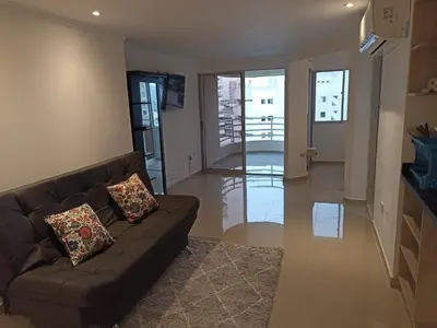 a living room with a couch and a balcony at Apartaestudio Altamar in Cartagena de Indias