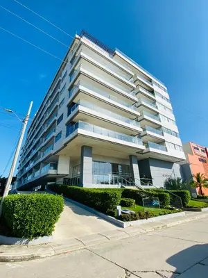 a tall white building with bushes in front of it at Artsy Oceanview Condo W Incredible Rooftop Pool in Cartagena de Indias
