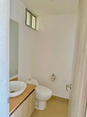 a bathroom with a white toilet and a sink at Artsy Oceanview Condo W Incredible Rooftop Pool in Cartagena de Indias