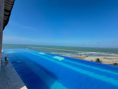a swimming pool with a view of the beach at Artsy Oceanview Condo W Incredible Rooftop Pool in Cartagena de Indias