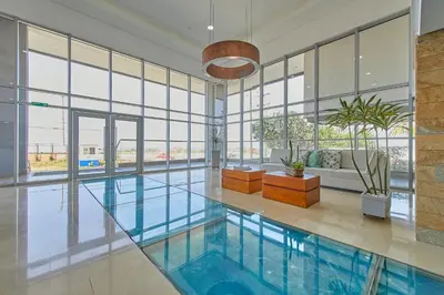 a pool in a building with glass windows at Artsy Oceanview Condo W Incredible Rooftop Pool in Cartagena de Indias