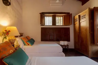 a bedroom with two beds and a couch at Casa Baloco in Cartagena de Indias