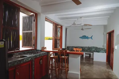 a kitchen with a sink and a counter top at Hostal Casa en la Ciénaga Rincon del Mar in Rincón