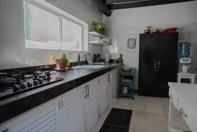 a kitchen with a sink and a stove top oven at Casa Ines in Santa Marta