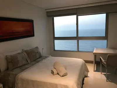 a bedroom with a bed with a pillow on it at Apartamento exclusivo frente al mar en Bocagrande in Cartagena de Indias