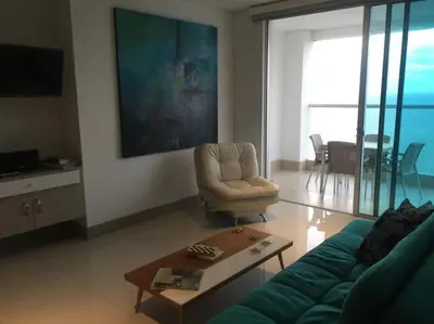a living room with a couch and a chair and a table at Apartamento exclusivo frente al mar en Bocagrande in Cartagena de Indias