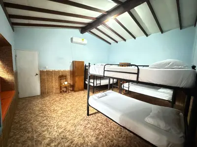 a dorm room with three bunk beds in it at Hostal Luna Llena Getsemaní in Cartagena de Indias