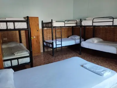 a room with three bunk beds and a bed at Hostal Luna Llena Getsemaní in Cartagena de Indias