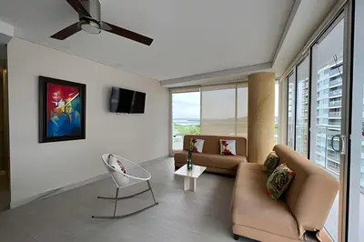 a living room with a couch and a chair at 2 Dormitorios Jacuzzi y Vista Mar. Frente a playa in Cartagena de Indias