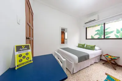 a small bedroom with a bed and a window at Hotel Ayenda Casa Cano 1805 in Cartagena de Indias