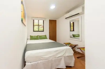 a bedroom with a bed and two windows at Hotel Ayenda Casa Cano 1805 in Cartagena de Indias