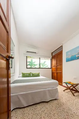 a bedroom with a bed and a window at Hotel Ayenda Casa Cano 1805 in Cartagena de Indias