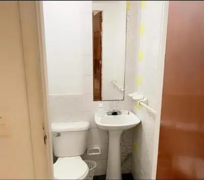 a bathroom with a toilet and a sink and a mirror at MR1-1G APARTAMENTO BASICO CERCA AL MAR CON AIRE ACONDICIONADO Y WIFi PARA 4 PERSONAS in Cartagena de Indias