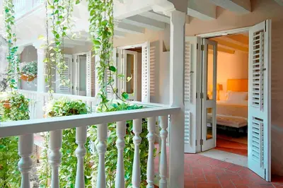 a balcony of a house with a bedroom at Hotel Casa Don Sancho By Mustique in Cartagena de Indias