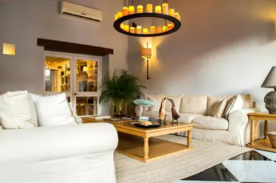 a living room with a white couch and a coffee table at Hotel Casa Don Sancho By Mustique in Cartagena de Indias
