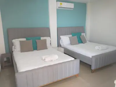 two beds with towels on top of them in a room at CC House Cartagena in Cartagena de Indias