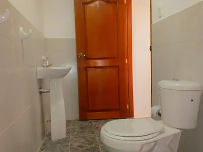 a bathroom with a toilet and a sink at CC House Cartagena in Cartagena de Indias