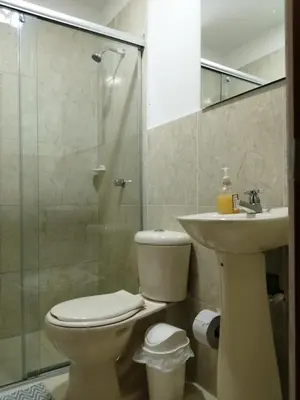 a bathroom with a toilet and a sink and a shower at CC House Cartagena in Cartagena de Indias