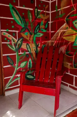 a red bench sitting in front of a brick wall at Hostal La Guaca in Cartagena de Indias