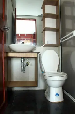 a small bathroom with a toilet and a sink at Hostal La Guaca in Cartagena de Indias