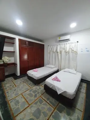 a room with two beds in a room at CASA ZOE in Cartagena de Indias