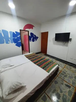 a bedroom with a bed and a flat screen tv at CASA ZOE in Cartagena de Indias