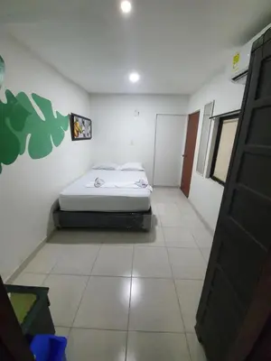 a bedroom with a bed in the corner of a room at CASA ZOE in Cartagena de Indias
