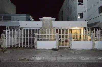 a white fence in front of a building at night at CASA ZOE in Cartagena de Indias
