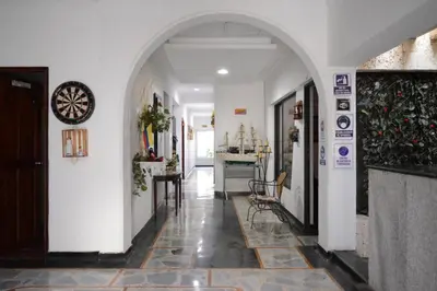 an empty hallway with a clock on a wall at CASA ZOE in Cartagena de Indias