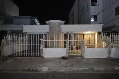 a white fence in front of a house at night at CASA ZOE in Cartagena de Indias