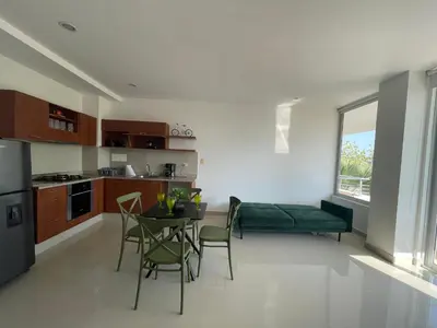 a kitchen and dining room with a table and chairs at Condominio Campestre Laguna Club Cartagena in Los Arrayanes